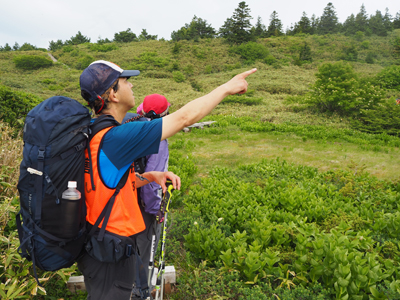 Iさんが撮影した東吾妻山に向かって指さしているFさんの写真
